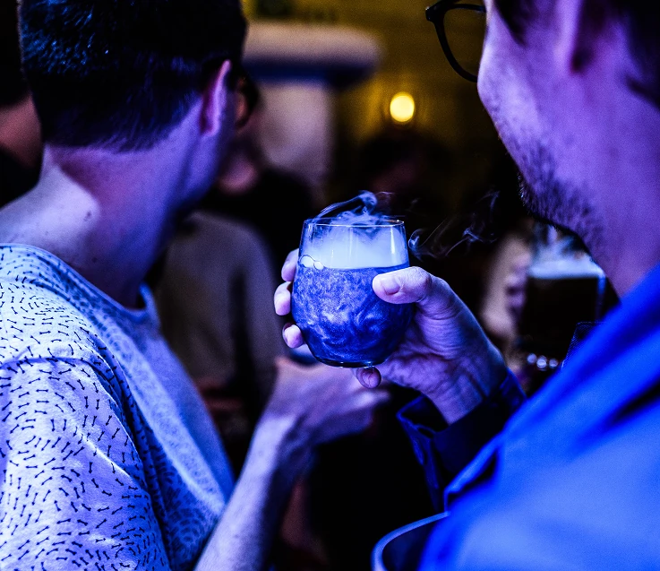 Guests gathered around a smoking drink